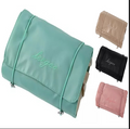 Organizador plegable en verde con referencias de colores beige, negro y rosa